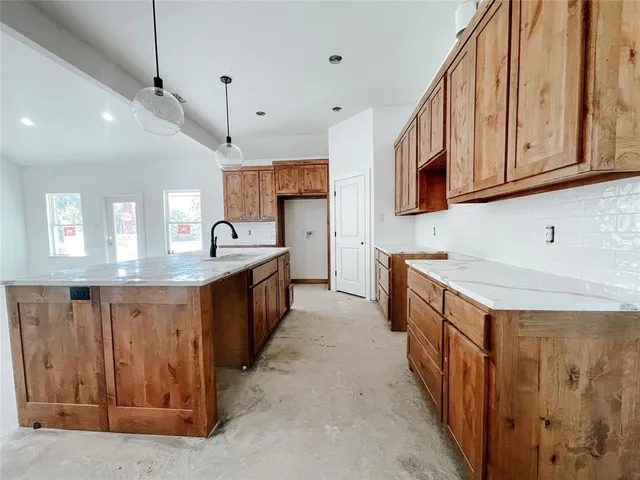 a kitchen with stainless steel appliances granite countertop a sink and cabinets