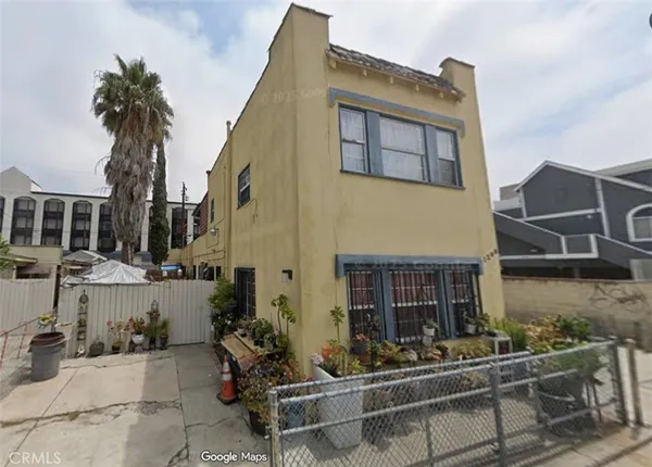 a front view of a house with outdoor seating and a potted plant