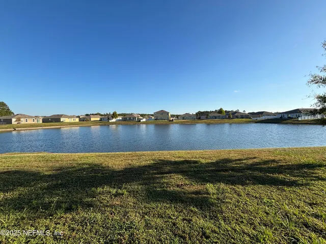 a view of a lake with houses in the background