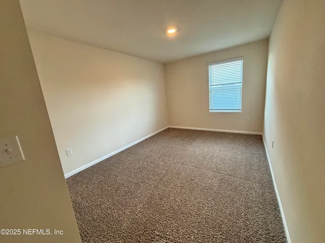 an empty room with a empty space and windows