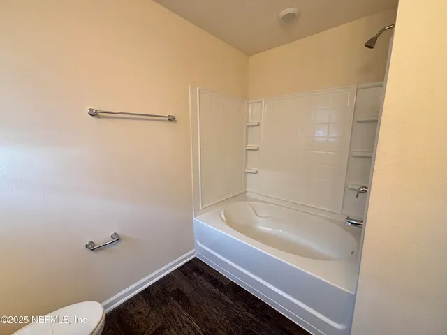 a bathroom with a tub and a shower