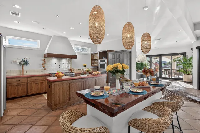 a living room with furniture a chandelier and a table