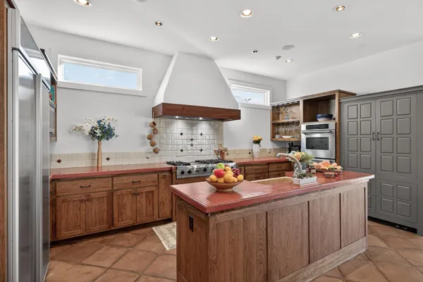 a kitchen that has a sink and a stove in it