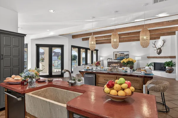 a view of a dining room with furniture a chandelier and wooden floor