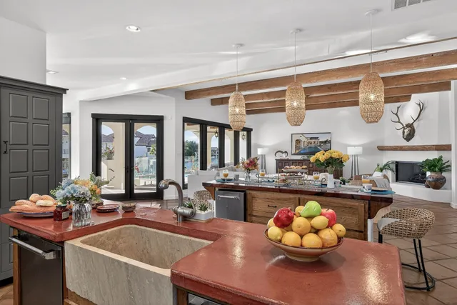 a view of a dining room with furniture a chandelier and wooden floor