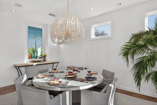 a bedroom with a bed couch and large window