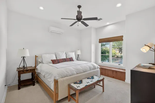 a bedroom with a bed and a chandelier