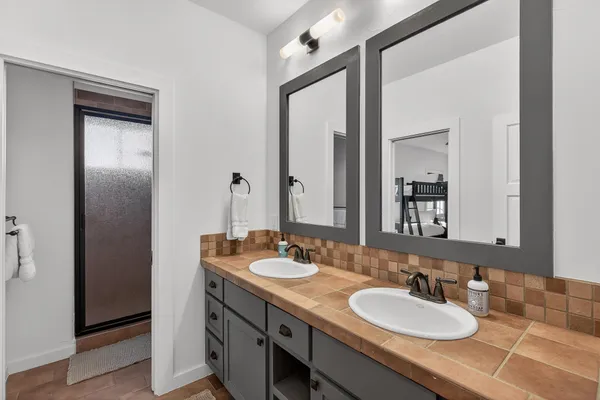 a bedroom with a large bed and a ceiling fan