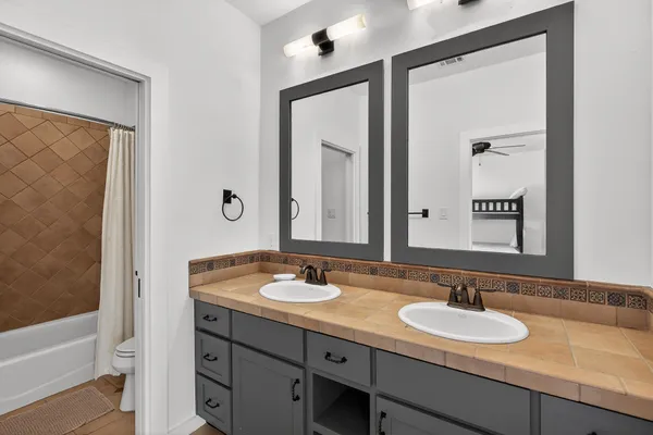 a bedroom with a bed window and a ceiling fan