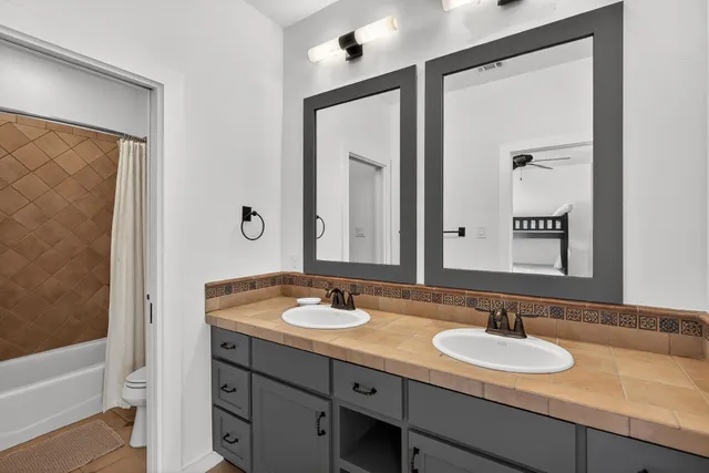 a bedroom with a bed window and a ceiling fan