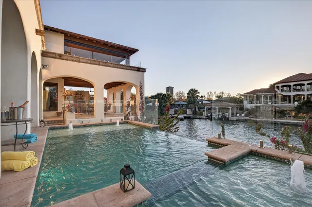 a swimming pool with outdoor seating and yard
