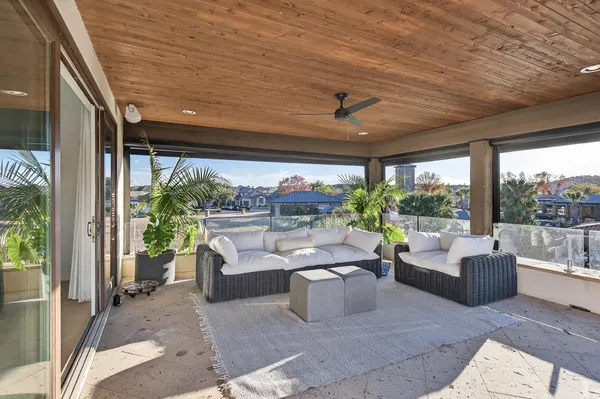 a living room with patio furniture and a potted plants