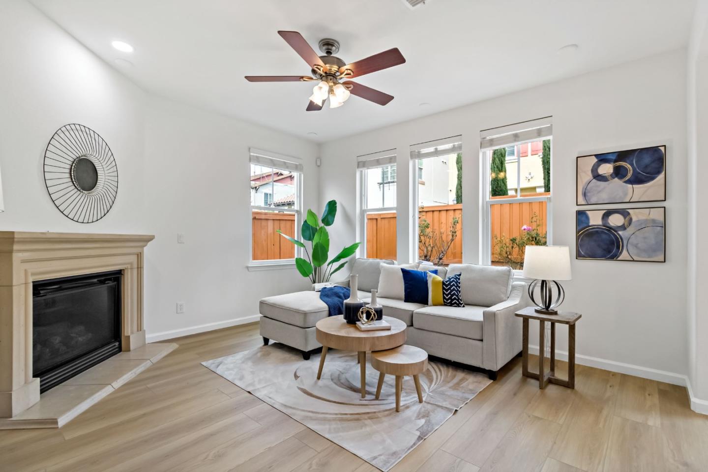 7394 Basking Ridge Avenue San Jose, CA 95138 - Photo 9 of 61 a living room with furniture a fireplace and a floor to ceiling window
