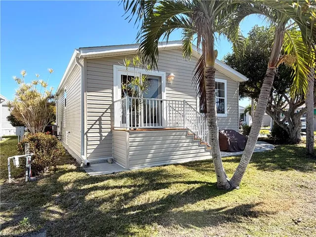a view of a house with backyard and sitting area