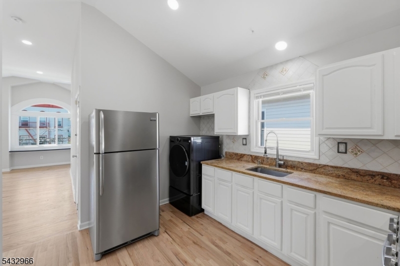 130 3rd Street, Unit 2 Passaic, NJ 07055 - Photo 3 of 12 a kitchen with a refrigerator a sink and dishwasher