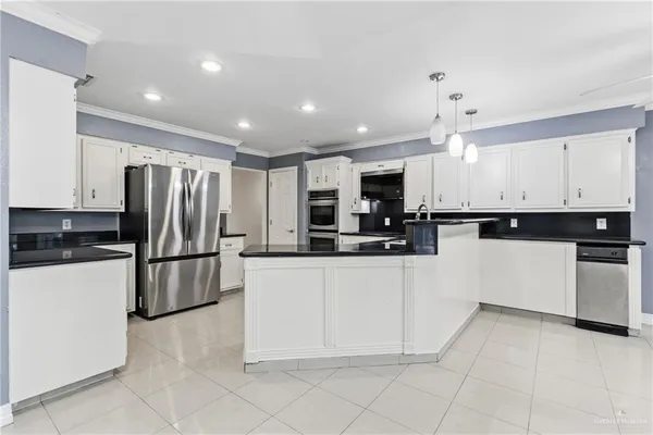 a kitchen with stainless steel appliances granite countertop a refrigerator and a stove top oven