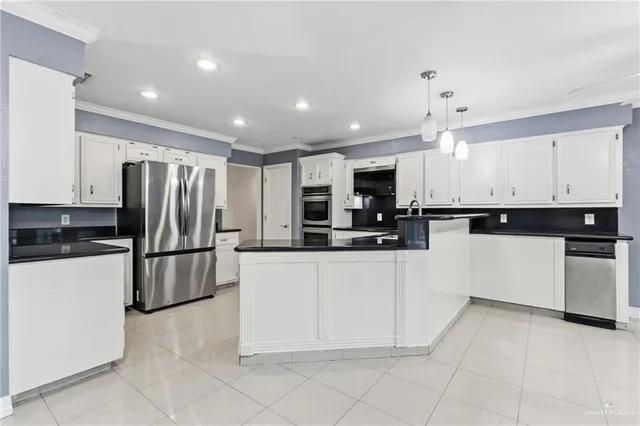 a kitchen with stainless steel appliances granite countertop a refrigerator and a stove top oven
