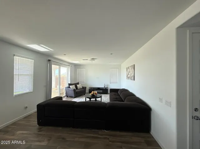 a bedroom with a bed window and couch