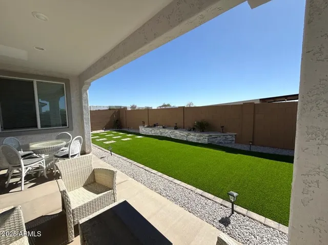 a view of a patio with chairs and a table