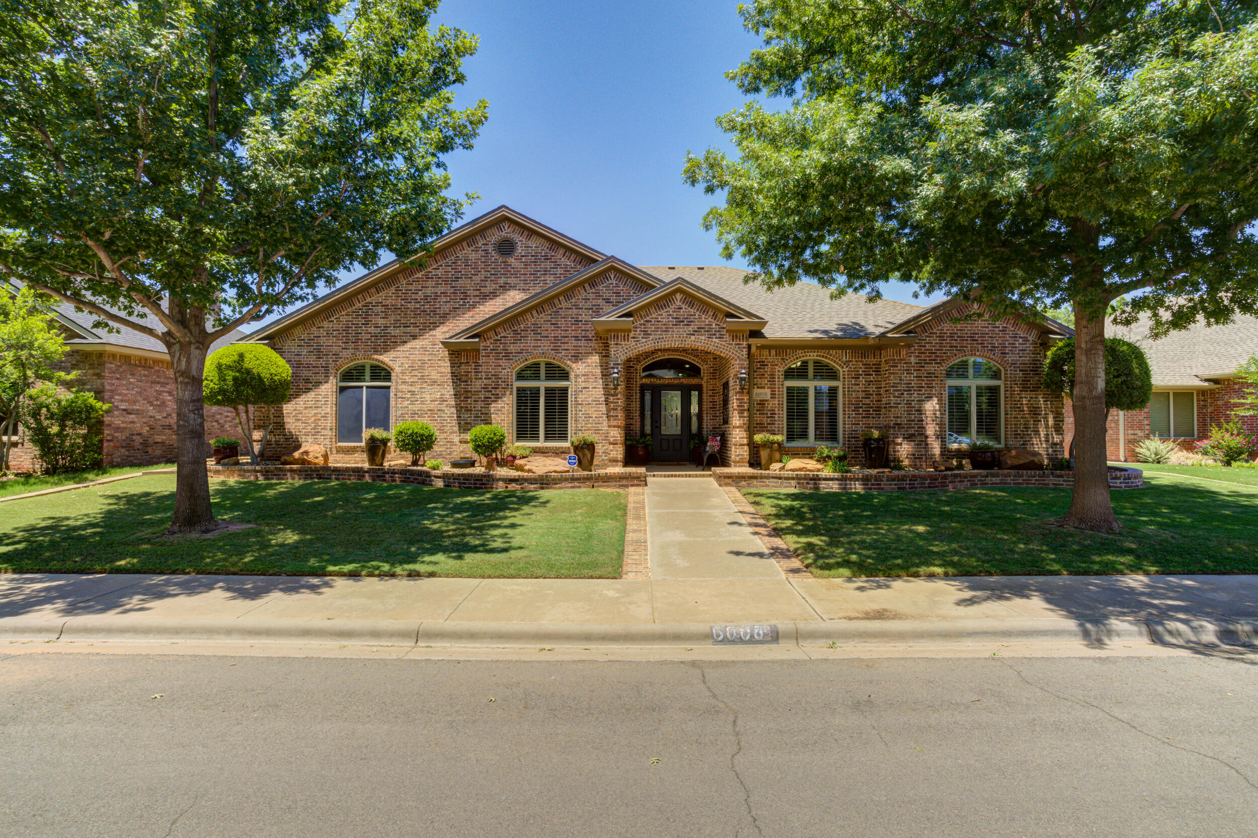 6008 89th Street Lubbock, TX 79424 - Photo 1 of 61 a front view of a house with a yard