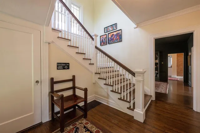 a view of entryway and hall with wooden floor
