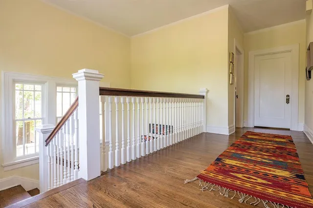 a view of a room with wooden floor and stairs