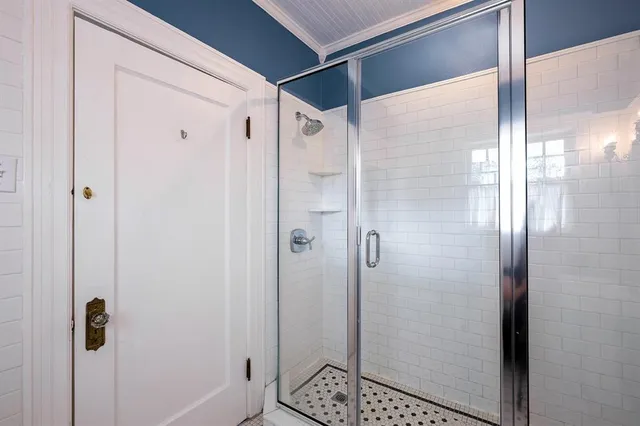 a bathroom with a glass shower door