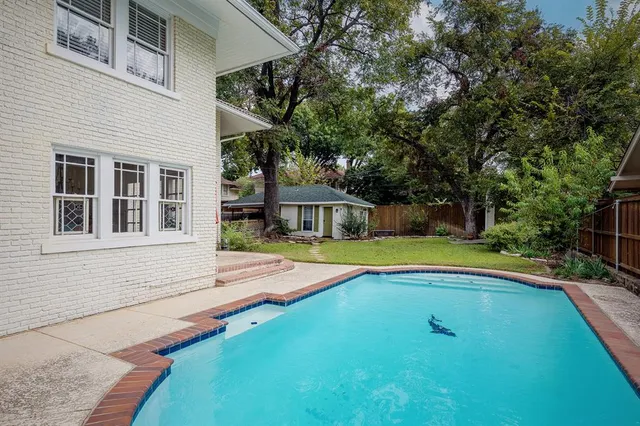 a view of a house with swimming pool and sitting area