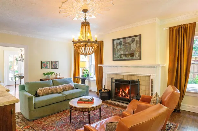 a living room with furniture a window and a fireplace