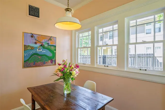 a dining room with furniture and a window