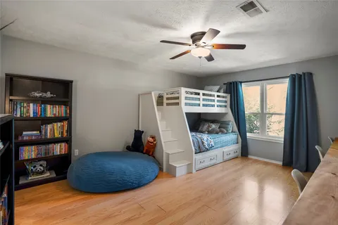 a bedroom with a large bed and a chandelier