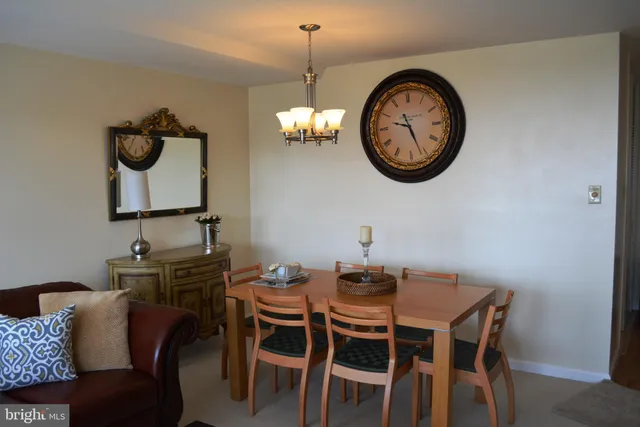 a view of a dining room with furniture and a chandelier