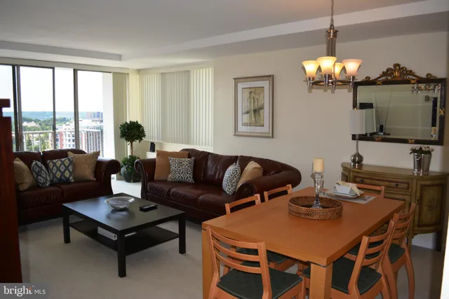 a living room with furniture a window and a chandelier