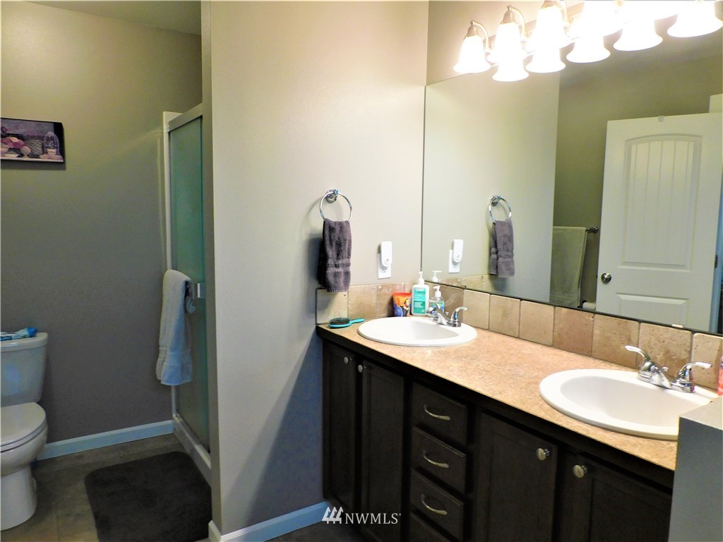 231 Sharp Road Tieton, WA 98947 - Photo 11 of 27 a bathroom with a sink a toilet a mirror and vanity