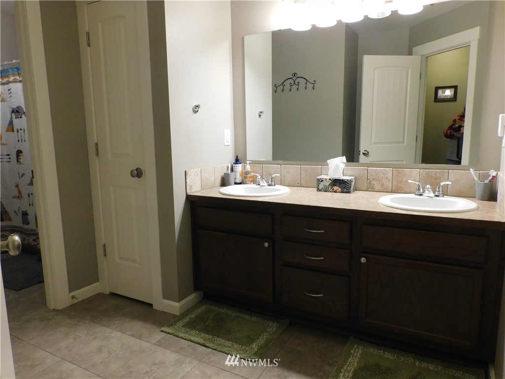 231 Sharp Road Tieton, WA 98947 - Photo 17 of 27 a bathroom with a double vanity sink and a mirror
