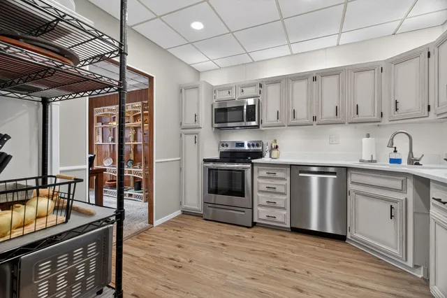 a kitchen with stainless steel appliances granite countertop a stove sink and cabinets