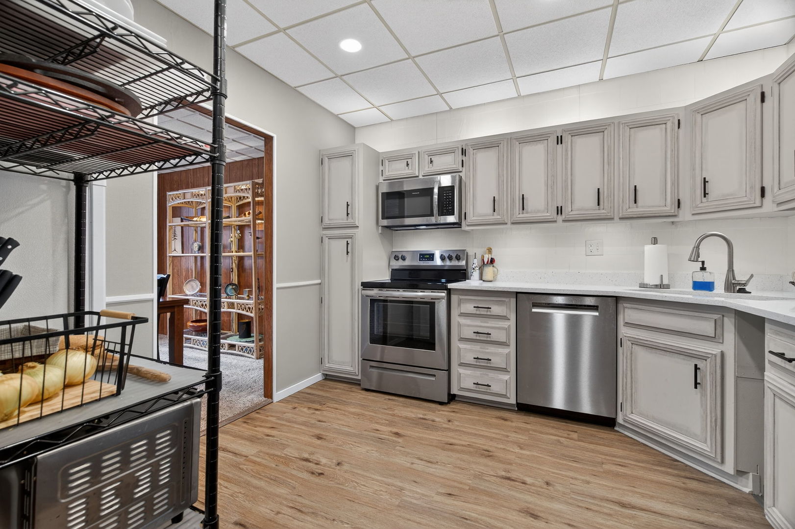 1504 Woodbridge Road, Unit 1A Joliet, IL 60436 - Photo 13 of 32 a kitchen with stainless steel appliances granite countertop a stove sink and cabinets