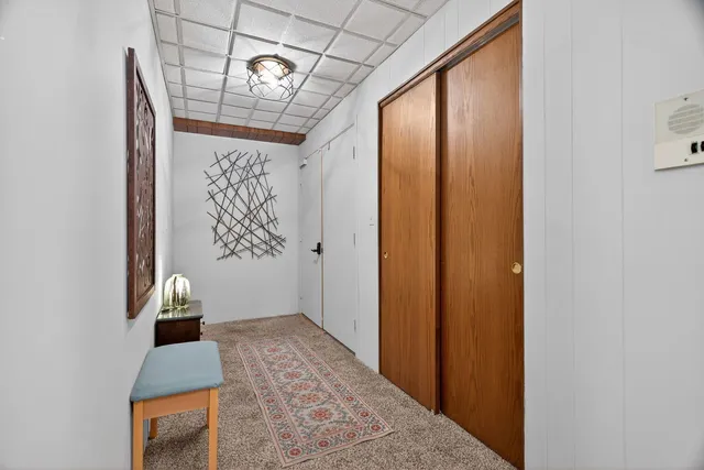 a bedroom with a bed mirror and window