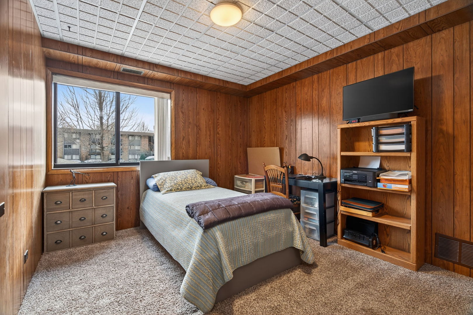 1504 Woodbridge Road, Unit 1A Joliet, IL 60436 - Photo 23 of 32 a bedroom with a bed and a dresser