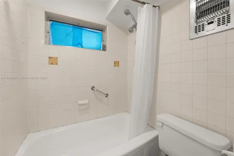 a bathroom with a toilet and bathtub