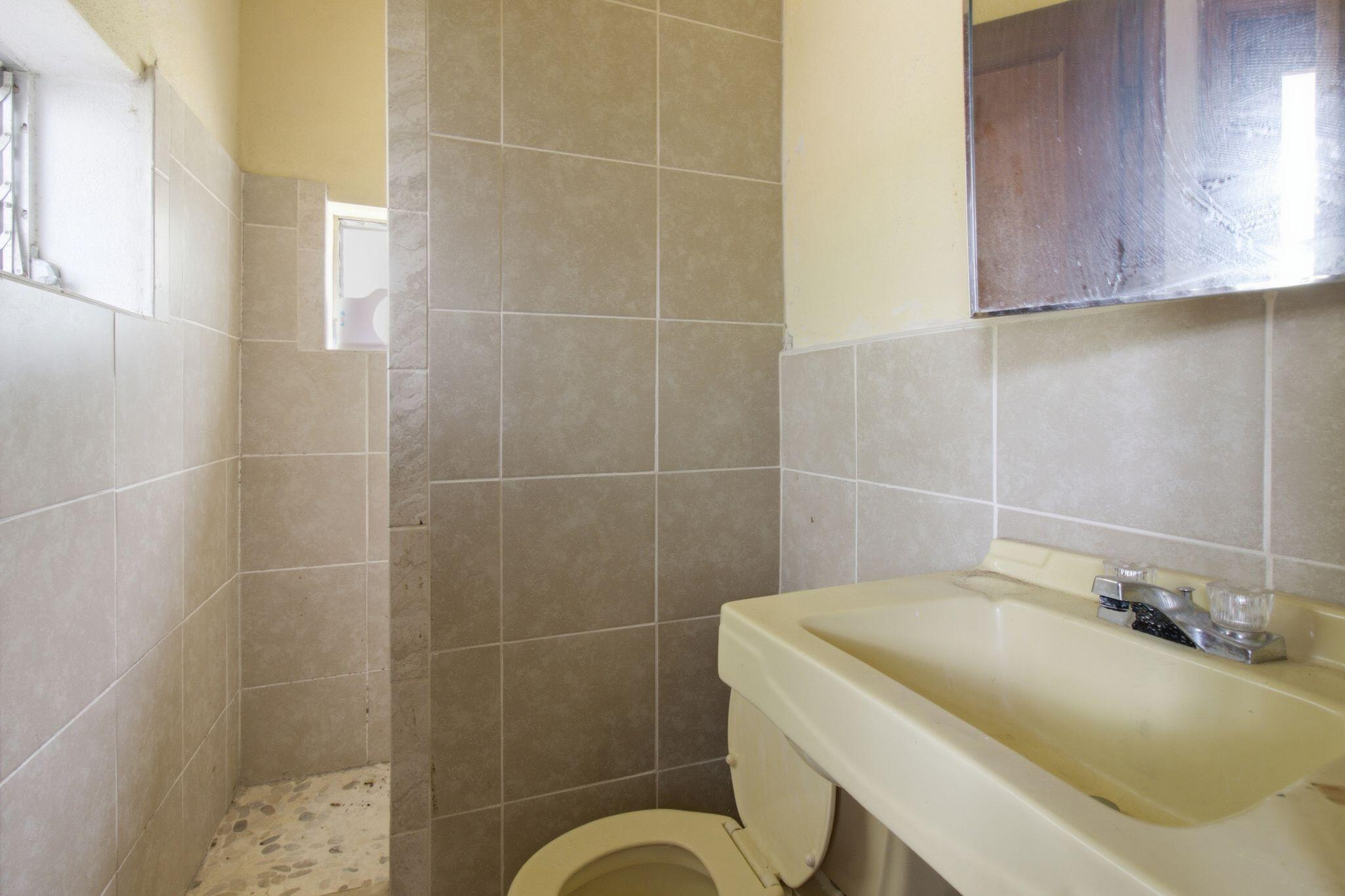 855 North Pearl Street Crestview, FL 32536 - Photo 27 of 31 a bathroom with a sink a toilet and a mirror