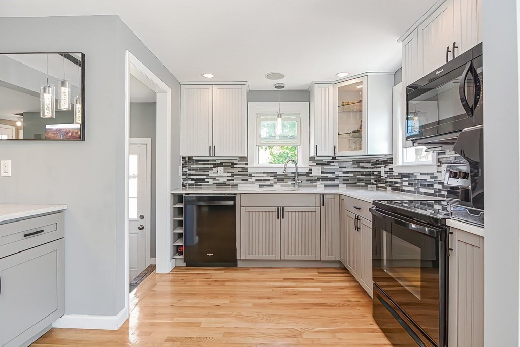 a kitchen with stainless steel appliances granite countertop a stove sink and cabinets