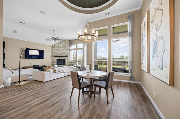 a view of a dining room with furniture wooden floor and a chandelier