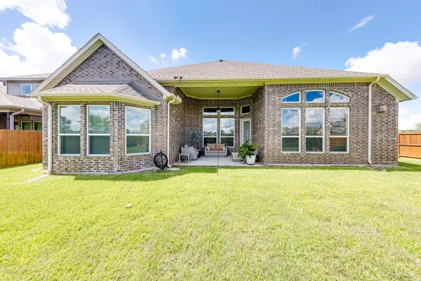 a view of a house with a backyard and porch