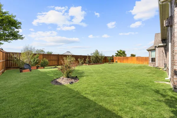 an aerial view of a house with a garden and swimming pool