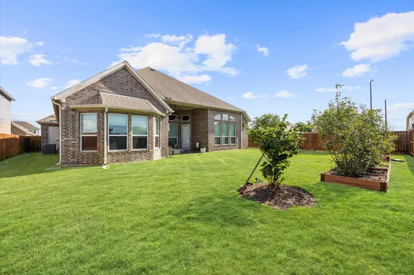 an aerial view of a house with a garden and yard