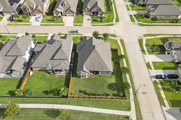 an aerial view of residential houses with outdoor space