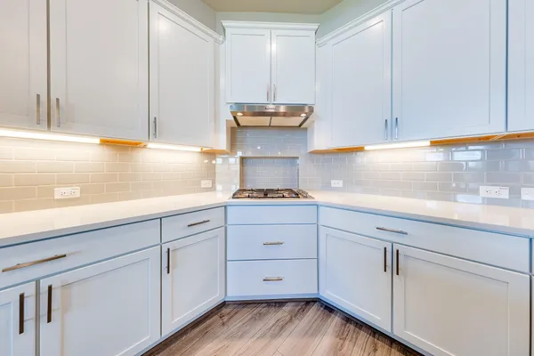 a kitchen with white cabinets and a sink