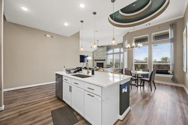 a kitchen with a stove a table and chairs