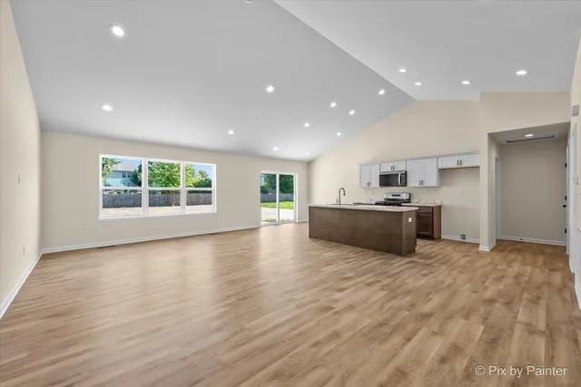 a view of kitchen and a window with wooden floor
